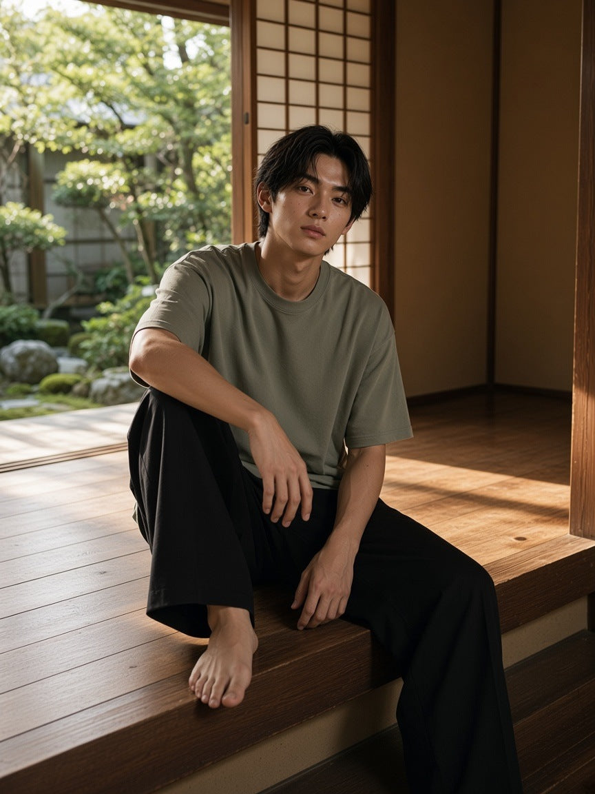 Man in the Men's Heavyweight Drop Shoulder T-Shirt in Grey Green in a ryokan corridor in Kyoto in the morning