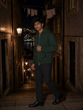 Man in a Blackish Green heavyweight full zip hoodie on a lamplit old-town stairway at night