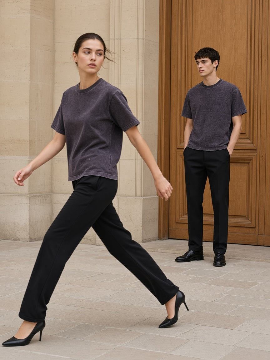 Two people in the Marcel Afters Mineral Wash Boxy Cotton T-Shirt in Dark Gray in a pale limestone Paris courtyard