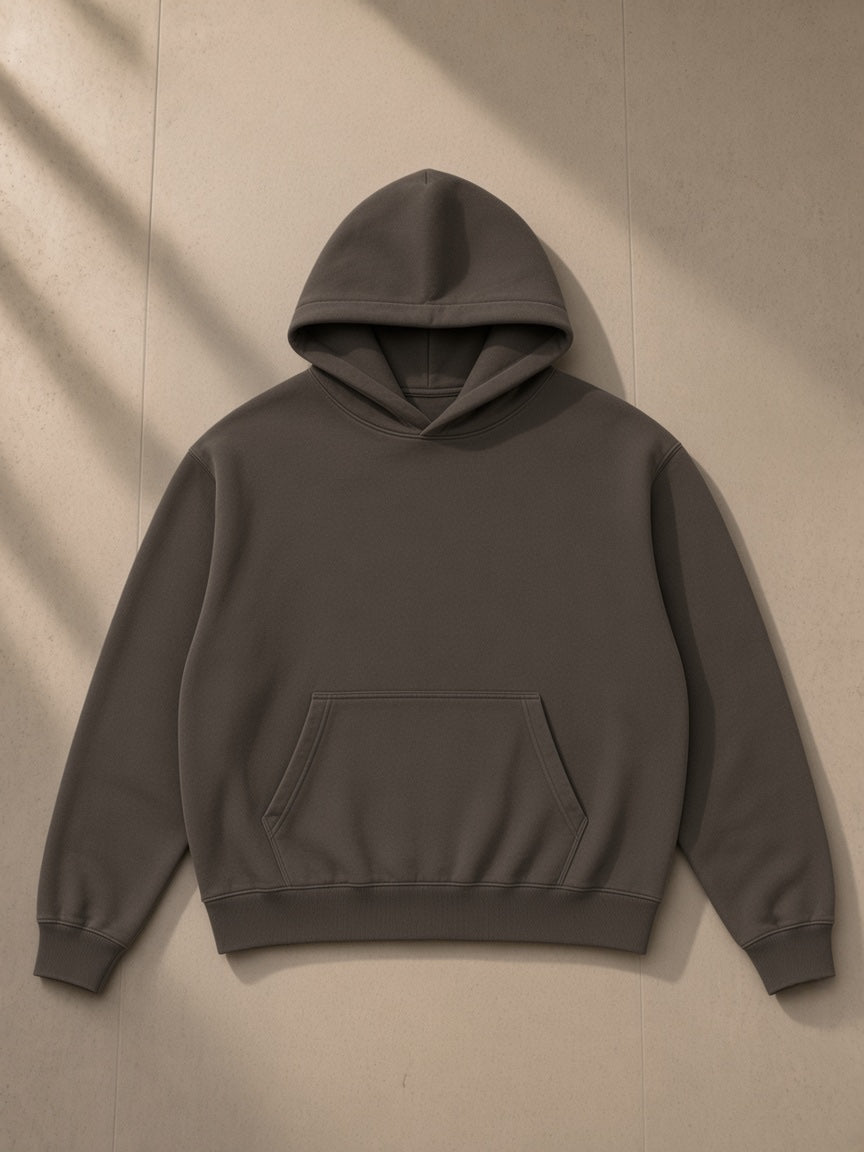 Mineral Wash Boxy Hoodie in Coffee, laid flat on pale limestone, front view