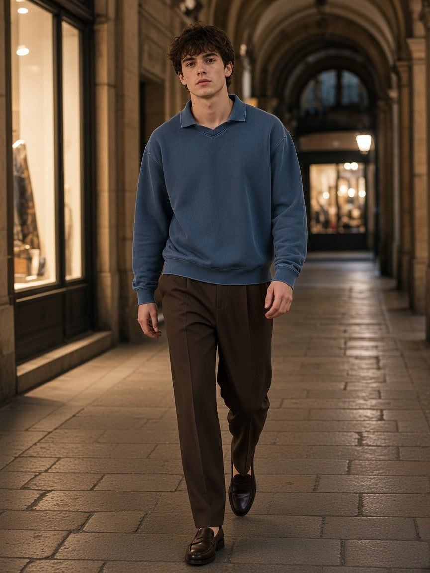 Woman in the Marcel Afters mineral wash pullover sweatshirt in Washed Blue standing in a harbour penthouse in Hong Kong at night