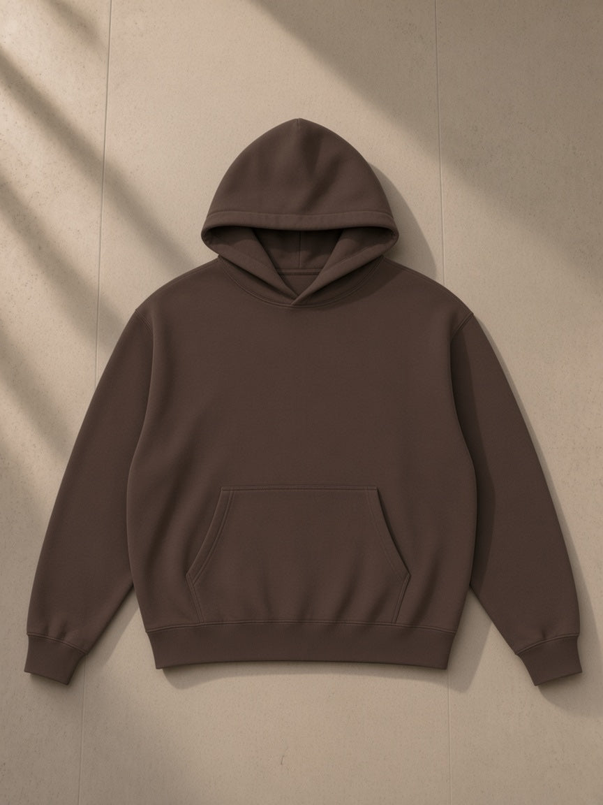 Oversized boxy fit fleece hoodie in Coffee, laid flat on pale limestone, front view