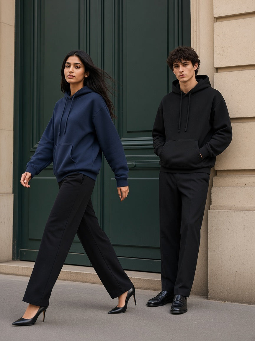 Two people in the Marcel Afters Oversized Drop Shoulder Hoodie in Navy Blue and Black at a Haussmann doorway in Paris