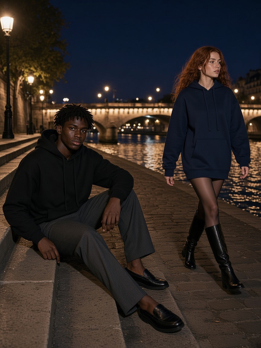 Marcel Afters Oversized Drop Shoulder Hoodie, 360 gsm in Navy Blue, worn by a man and a woman, on Seine-side stone steps at night, he in black and she in navy oversized hoodies