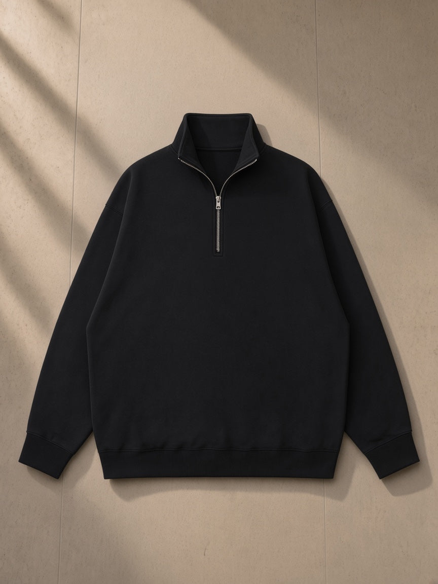 Quarter-Zip Drop Shoulder Sweatshirt in Black, laid flat on pale limestone, front view
