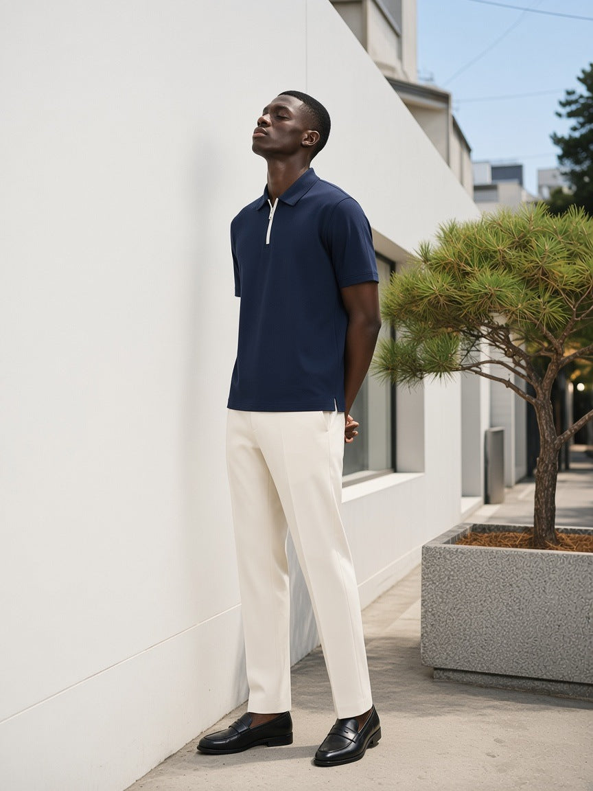 Man in the Quarter-Zip Knit Polo in Navy Blue, looking up at a white gallery facade in Hannam-dong, Seoul in the morning