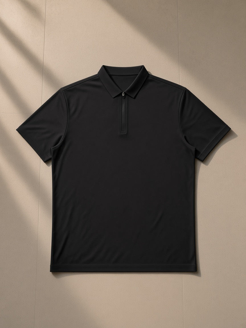 Men's Quarter-Zip Performance Polo Shirt in Black, laid flat on pale limestone