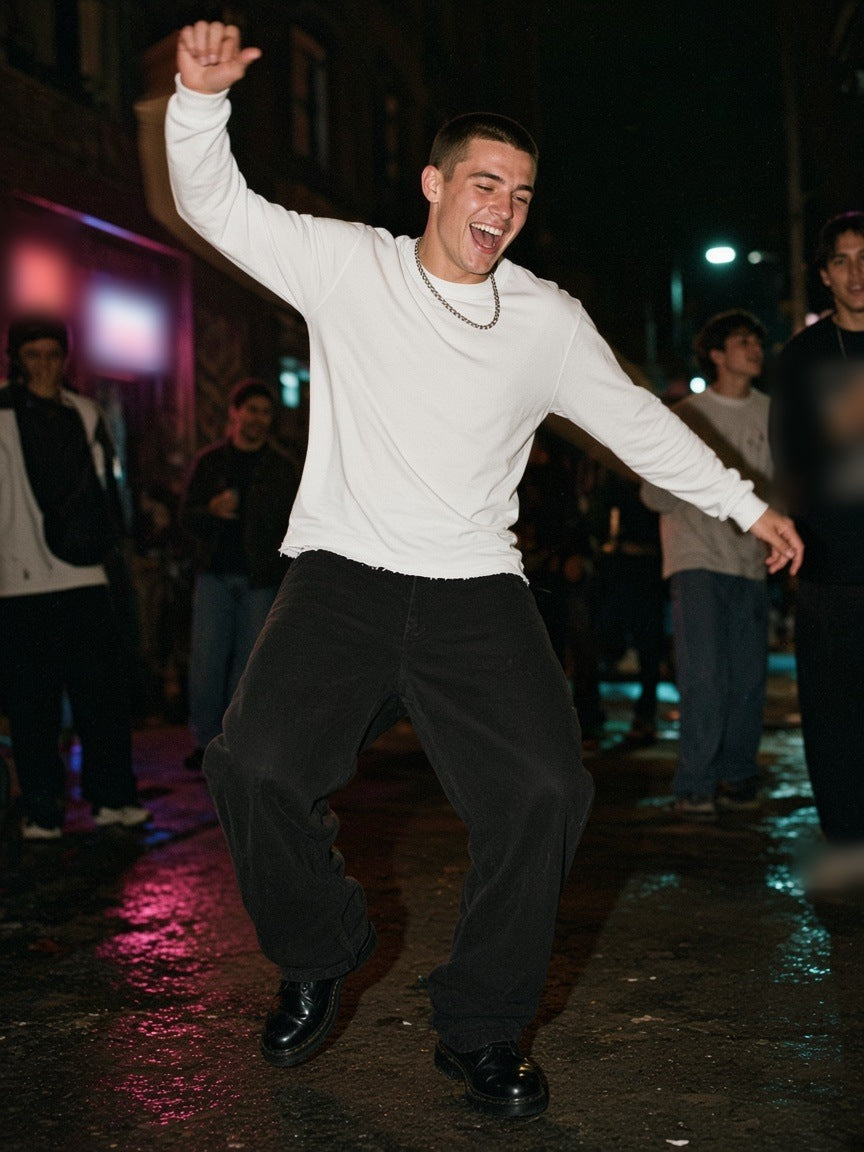 Man in the Raw Hem Long Sleeve T-Shirt in White, dancing on a Brixton street corner at 2am