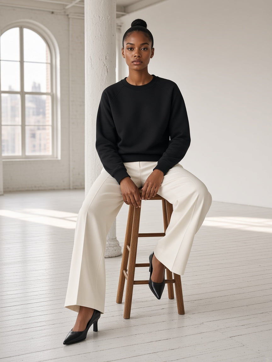 Woman in the Marcel Afters Regular Fit Crewneck Sweatshirt in Black in a SoHo loft in New York