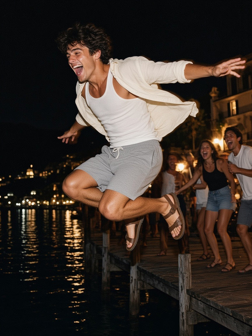 Man in the Regular Fit Shorts in Flower Gray, cannonballing off a Lake Como dock at 1am