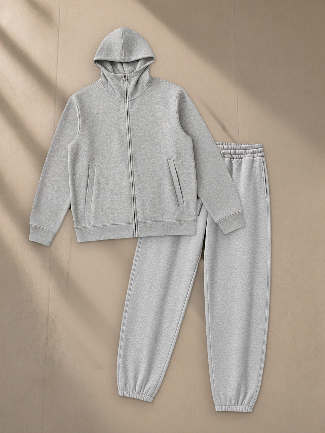 Women's Essential Heavyweight High Neck Zip-Up Hoodie + Heavyweight Fleece Joggers Set in Flower Gray, top and bottom laid flat together on pale limestone