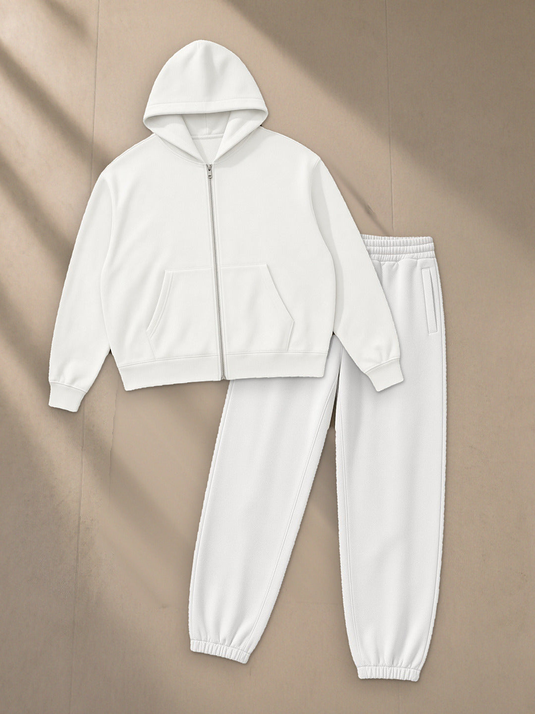 Men's Drop Shoulder Full Zip Hoodie + Heavyweight Fleece Joggers Set in White, top and bottom laid flat together on pale limestone