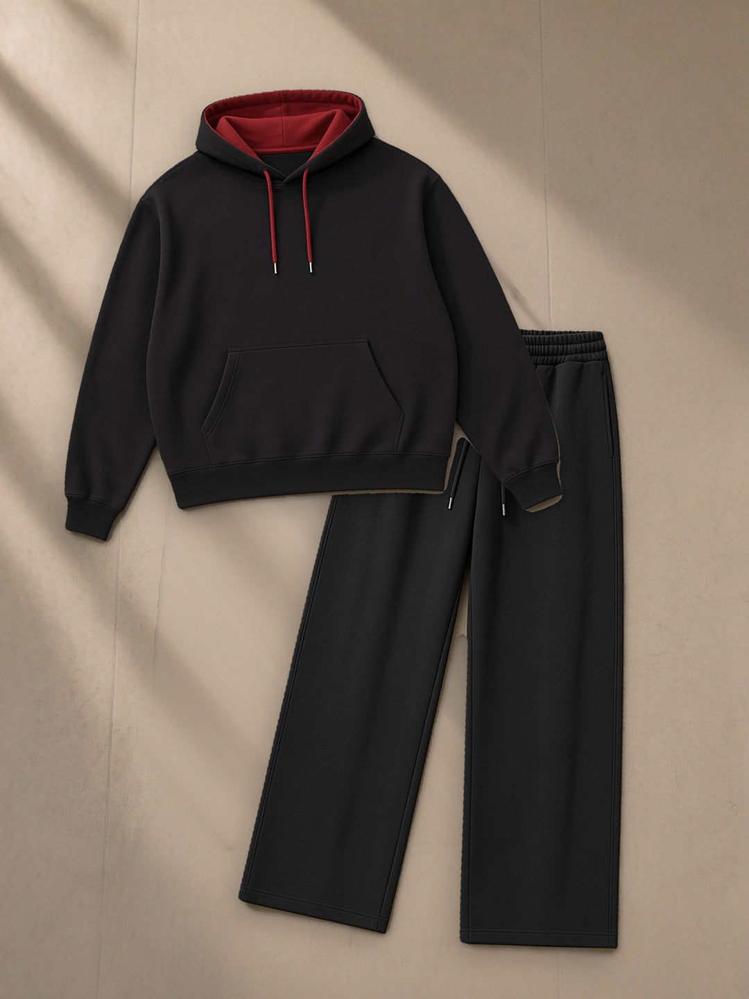 Contrast Drawstring Hoodie + Essential Straight-Leg Sweatpants Set in Black, top and bottom laid flat together on pale limestone