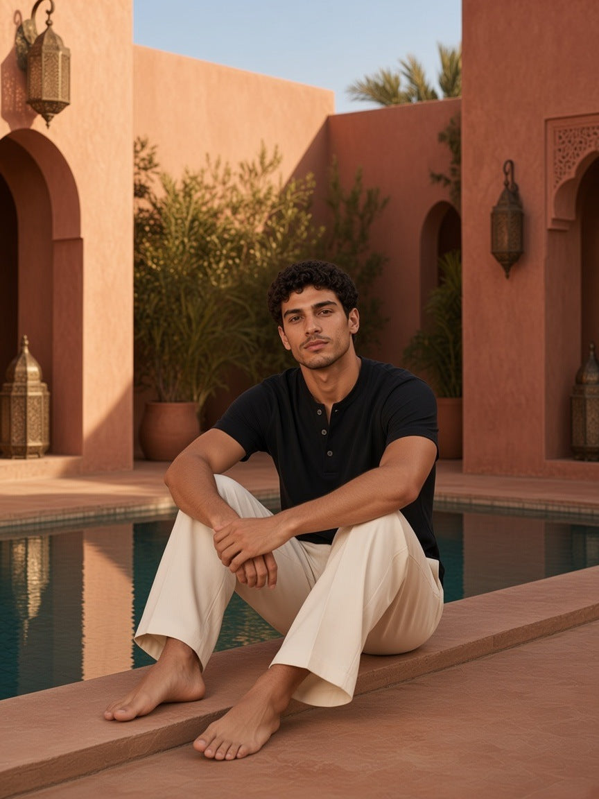 Man in the Short Sleeve Henley Shirt in Black, beside a riad pool in Marrakech in the morning
