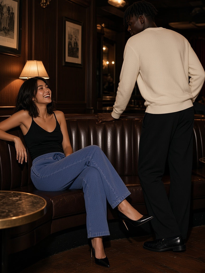 Two people in the Marcel Afters Snow Wash Heavyweight Sweatpants in Black and Dark Blue by a St Moritz chalet fire at night