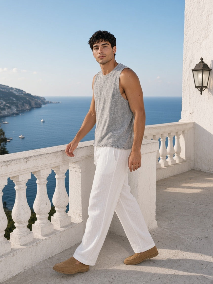 Man in the Snow Washed Frayed Hem Tank Top in Light Gray on a clifftop terrace in Capri in the morning