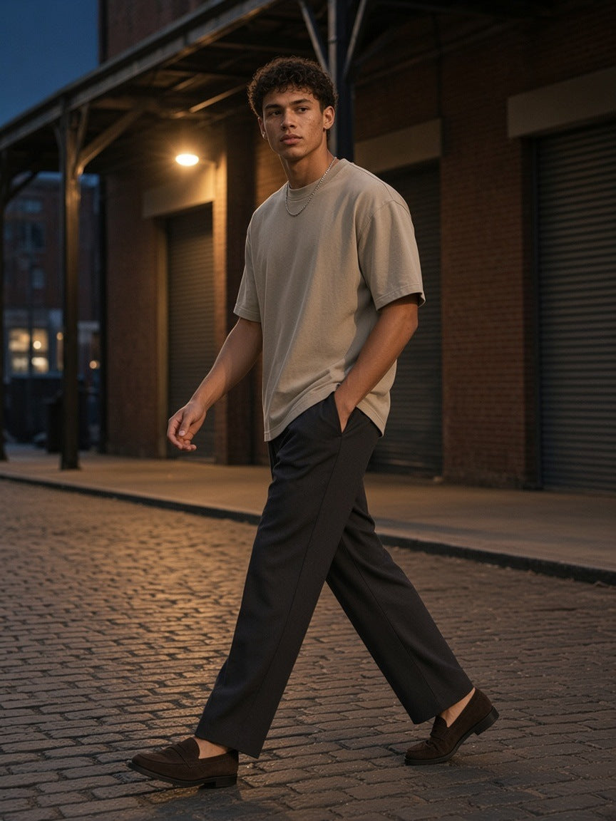 Man in the Marcel Afters Snow Washed Heavyweight Oversize T-Shirt in Khaki on a Meatpacking cobbled street in New York at night