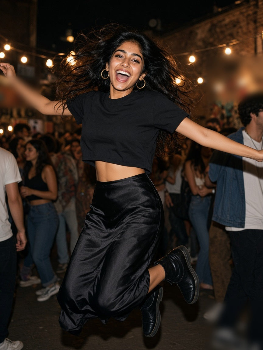 Woman in the Marcel Afters Snow Washed Raw Edge Crop Top in Black, in a hotel suite at night in Mumbai