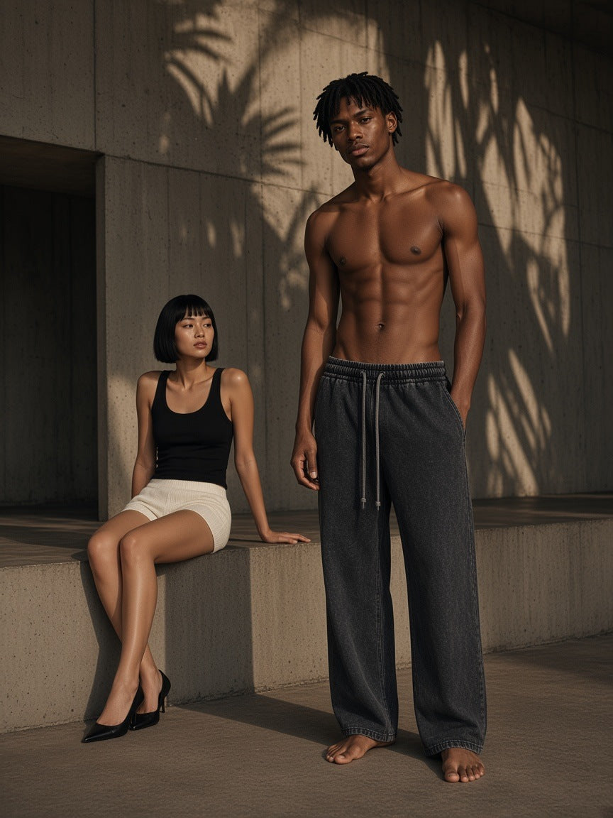 Two people in Marcel Afters, the Snow Washed Straight Leg Pants in Black, in a concrete pavilion at night in São Paulo