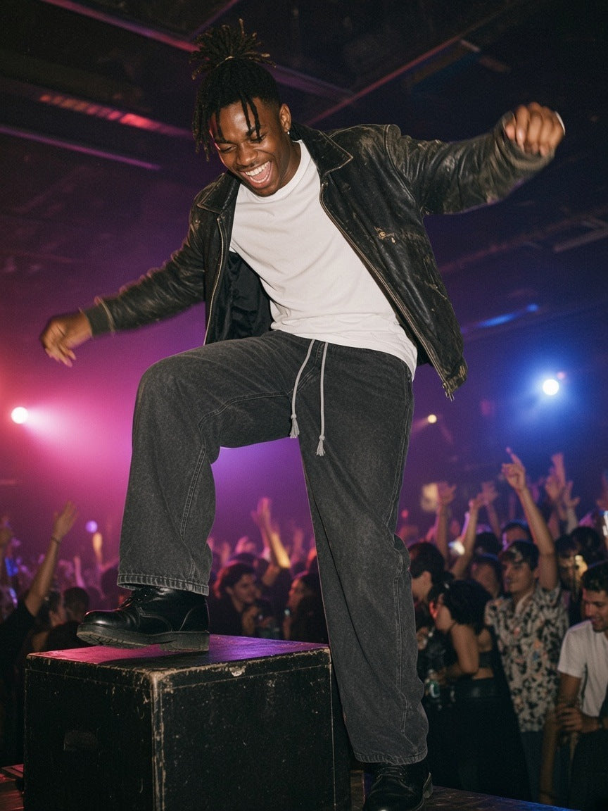 Man in the Snow Washed Straight Leg Pants in Black, dancing on a speaker at a Berlin warehouse party at 2am