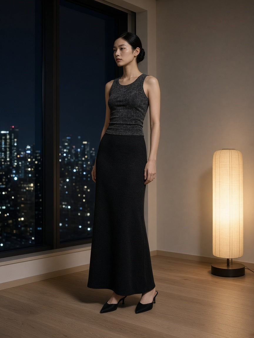 Woman in the Marcel Afters Snow Washed Tank Top in Black in a hotel suite in Tokyo at night