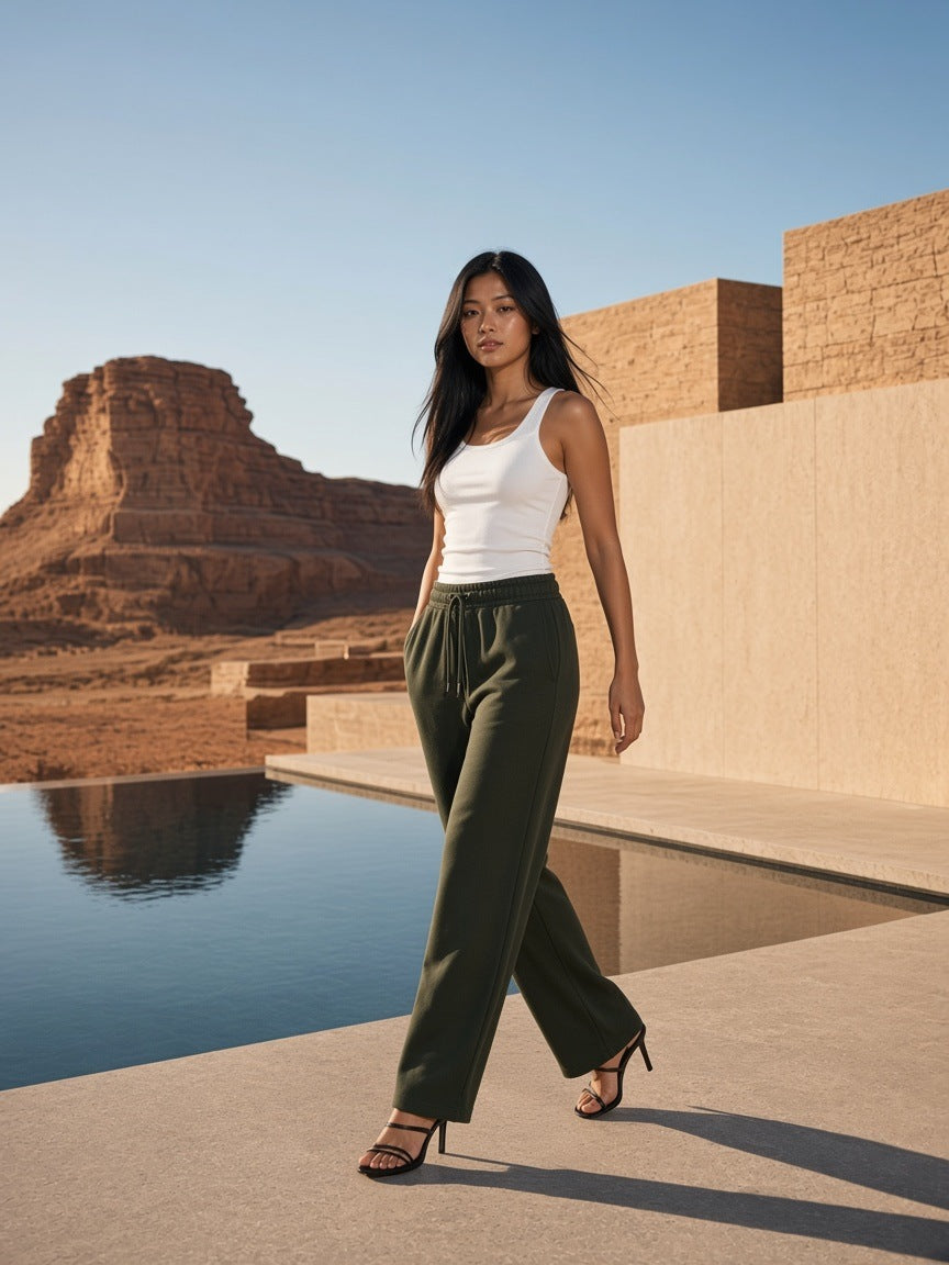 Woman in the Solid Color Straight-Leg Sweatpants in Blackish Green at a desert resort pool at Amangiri in the morning