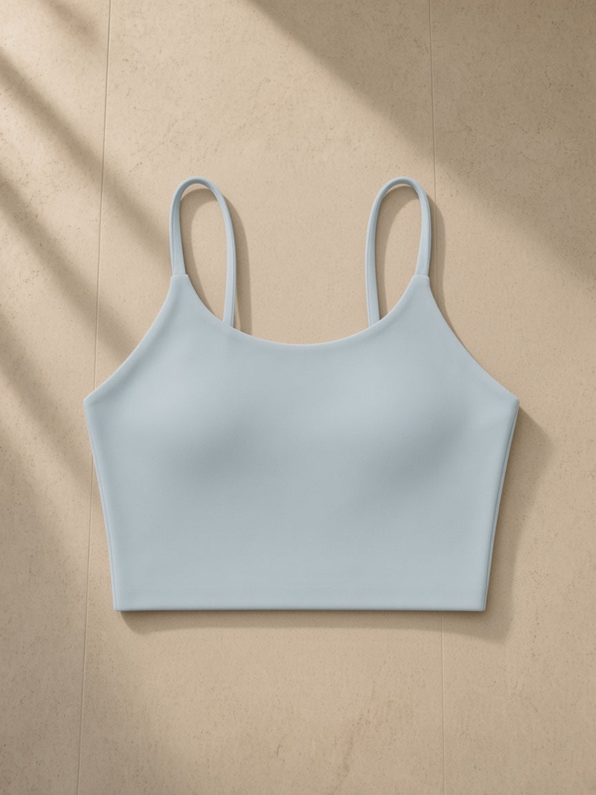 Spaghetti Strap Yoga Sports Bra in Haze Blue, laid flat on pale limestone, front view
