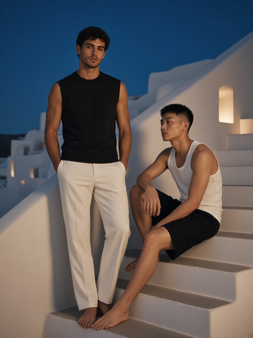 Two people in Marcel Afters, the Spliced Panel Sleeveless Muscle T-Shirt in Black, on a whitewashed stair at blue hour in Mykonos