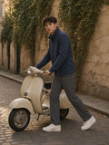 Man in the Stand Collar Jacket in Navy Blue pushing a vintage scooter along an ivy-lined Paris lane