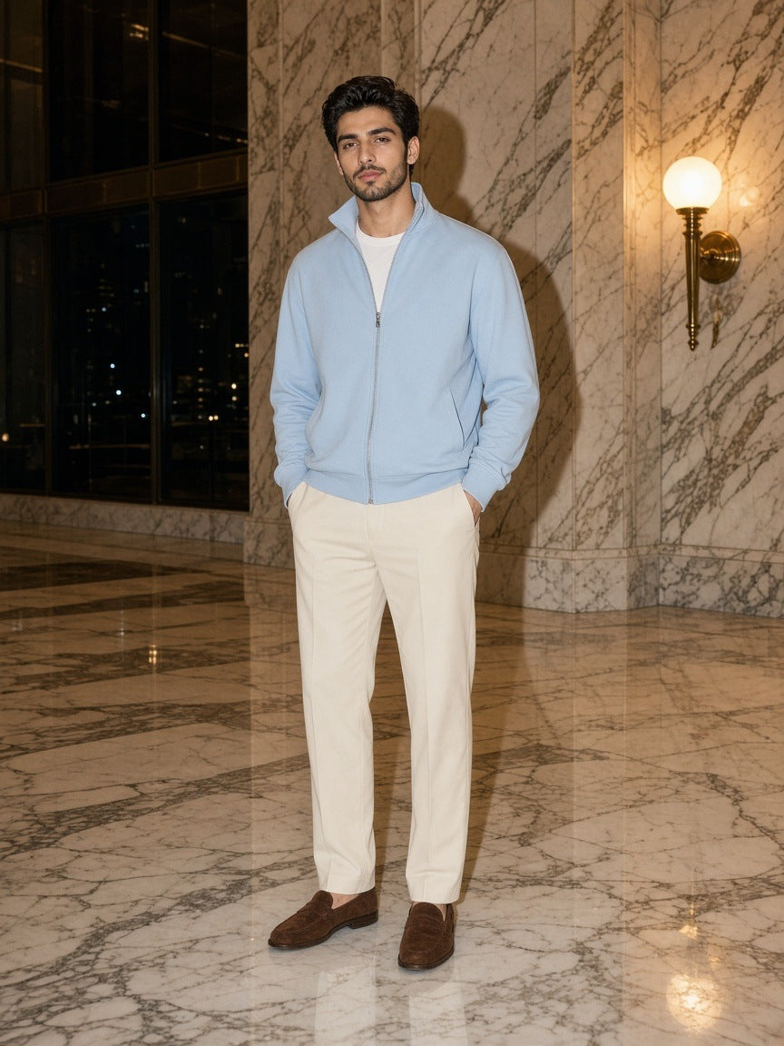 Man in the Marcel Afters Stand Collar Jacket in Light Blue in a marble hotel lobby in New York at night