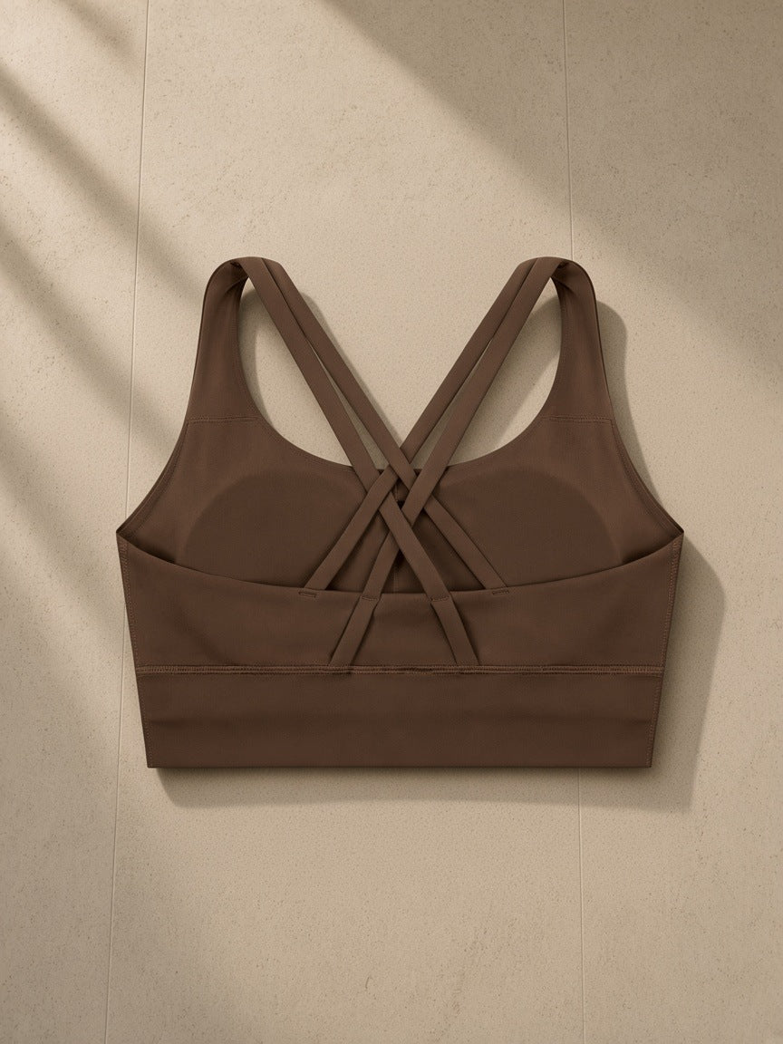 Strappy Criss-Cross Sports Bra in Chocolate Brown, laid flat on pale limestone, back view