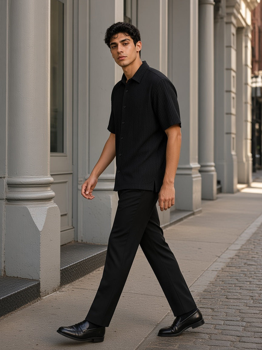Man in the Tencel Jacquard Shirt in Black, walking past cast-iron columns in SoHo, New York in the morning