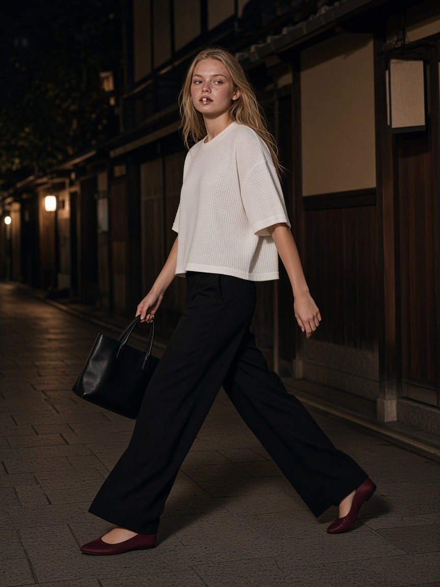 Woman in the Textured Waffle Washed Boxy T-Shirt in White walking Pontocho alley in Kyoto at night