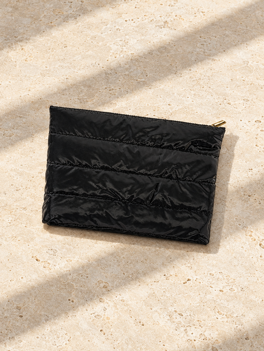 The Weekend Pouch in Black, Marcel flat lay on pale limestone