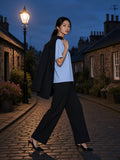 Woman in the Boxy Coolmax T-Shirt in Light Blue with wide black trousers on Circus Lane in Edinburgh at blue hour