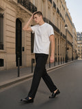 Man in the Boxy Raw Edge T-Shirt in White walking a Haussmann street in Paris in the morning