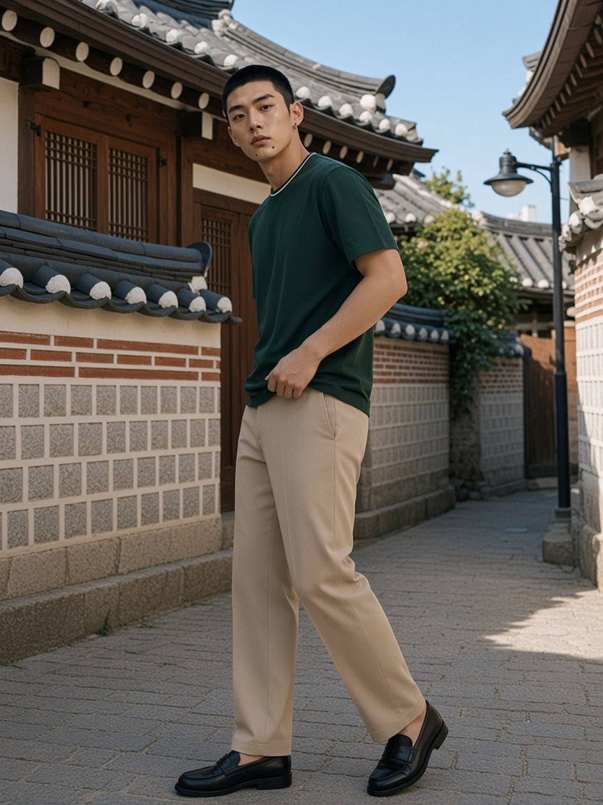Man in the Boxy Ribbed T-Shirt in Dark Green standing in a hanok courtyard in Seoul in the morning