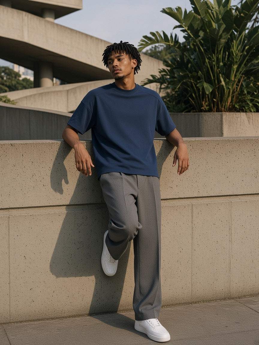 Woman in the Boxy Tonal Paneling T-Shirt in Navy Blue on a Brutalist plaza in São Paulo in the morning