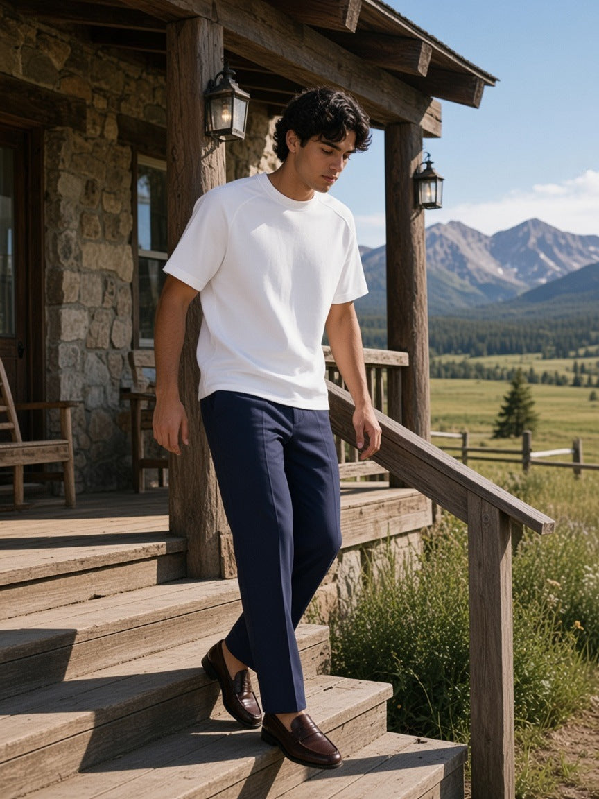 Man in the Boxy Tonal Paneling T-Shirt in White on the porch of a ranch lodge in Montana in the morning