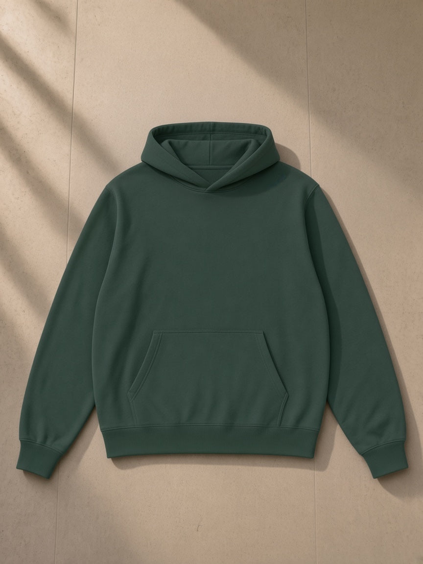 Unisex fleece regular shoulder hoodie in Dark Green, laid flat on pale limestone, front view