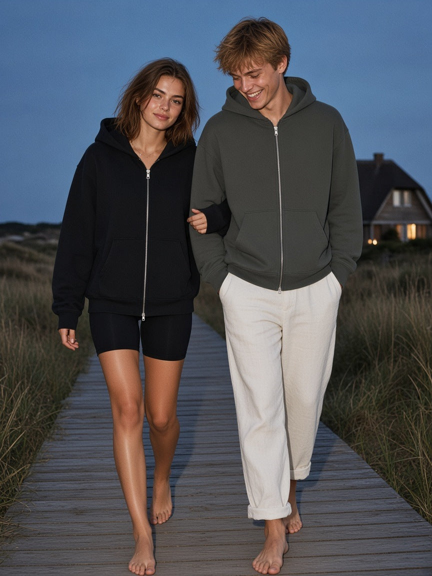 Two people in the Marcel Afters Heavyweight Full Zip Boxy Hoodie in Dark Gray and Black on a Sylt dune boardwalk at blue hour