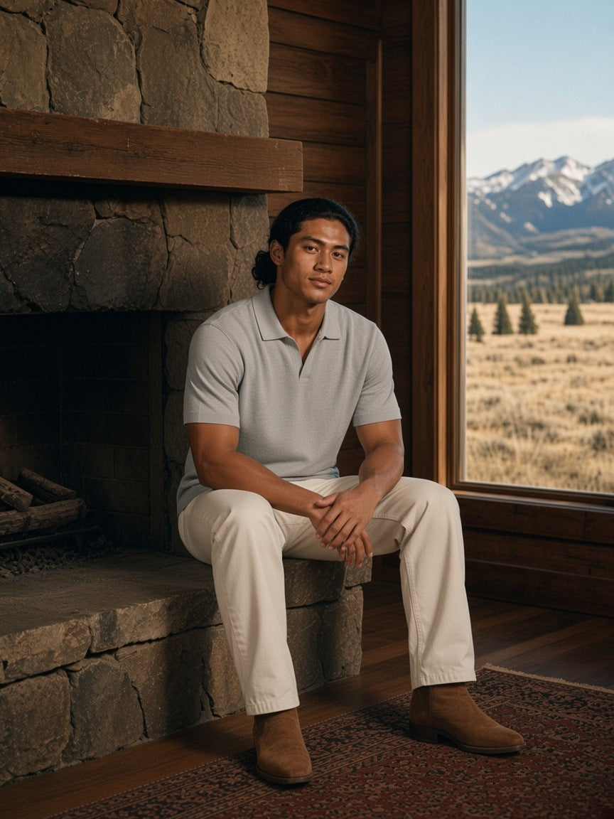 Man in the Heavyweight Oversized Polo Shirt in Flower Gray sitting on the hearth in a ranch lodge in Montana in the morning