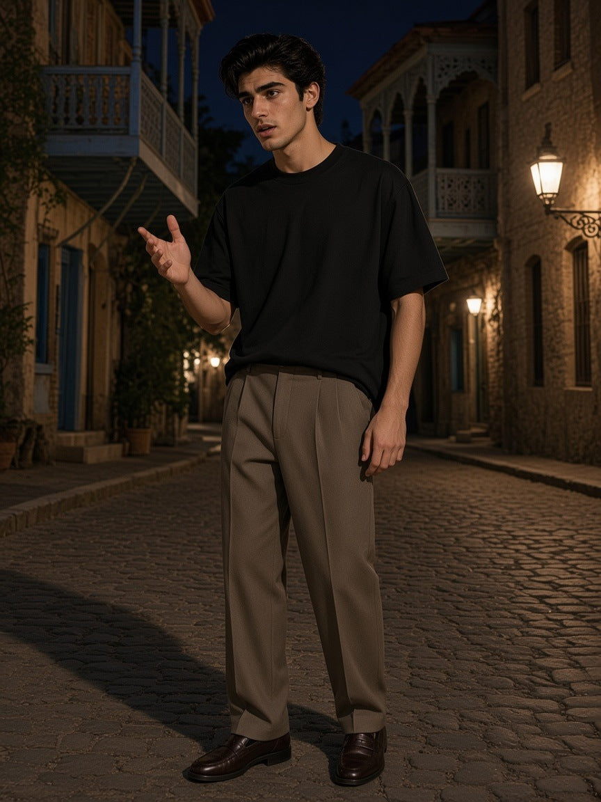 Man in the Marcel Afters Heavyweight Oversized T-Shirt in Black on an old-town street in Tbilisi at night