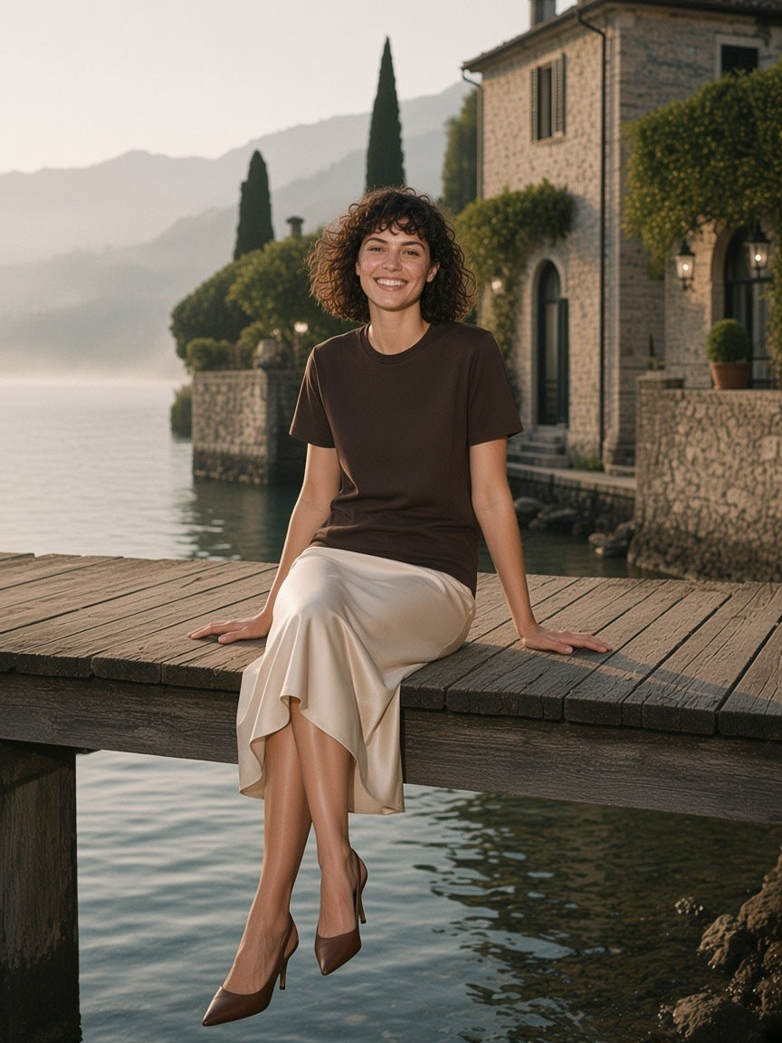Woman in the Mid-Weight Cotton T-Shirt in Coffee standing on a villa dock on Lake Como in the morning
