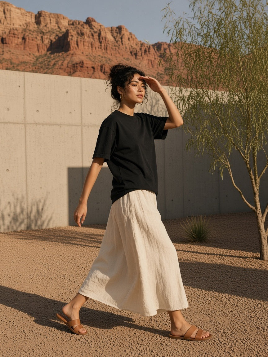 Man in the Oversized Cotton T-Shirt in Black, in a desert-modern concrete courtyard in Utah in the morning