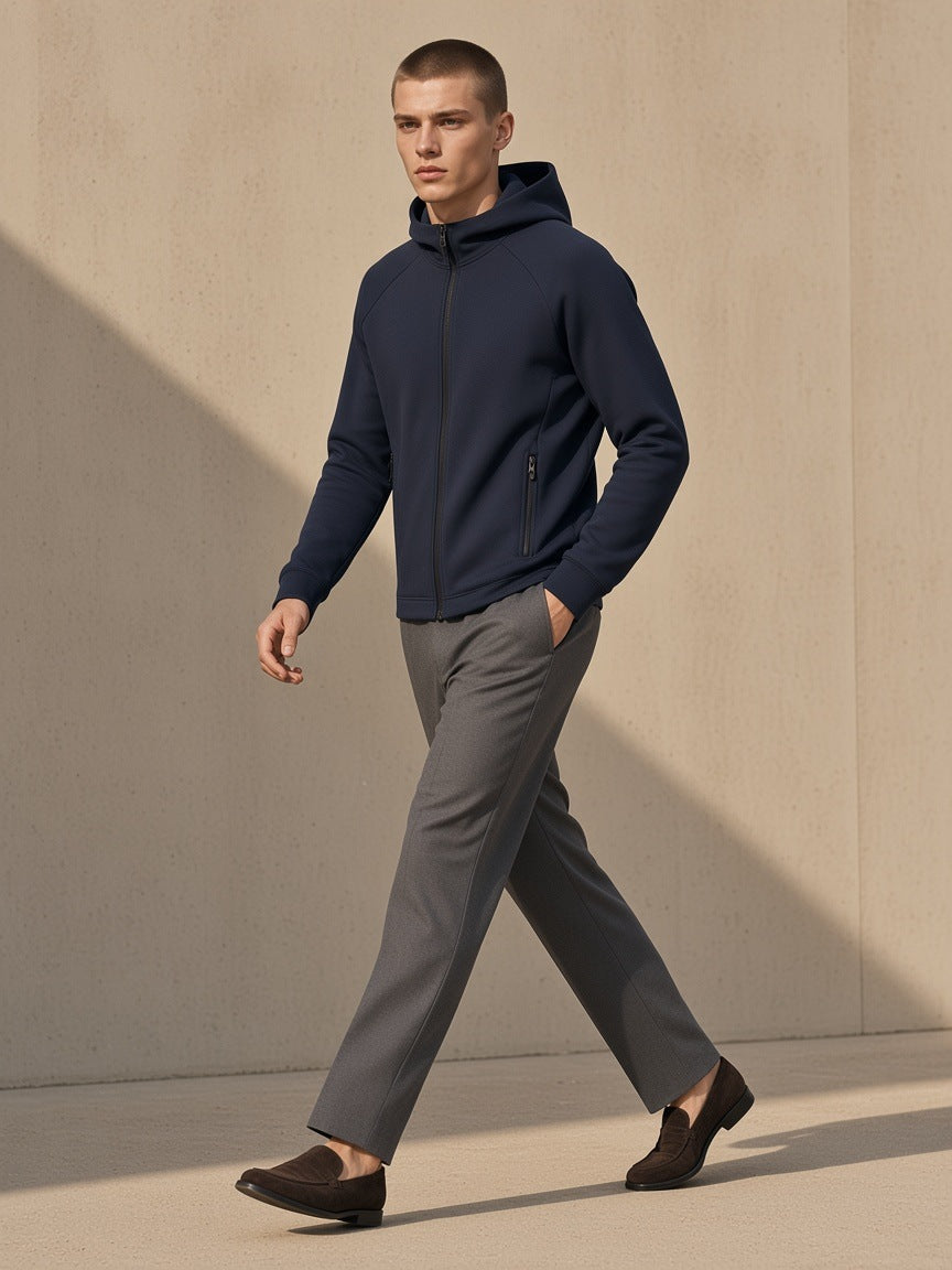 Man in the Marcel Afters Paneled Full-Zip Hoodie in Navy Blue, against a sand-toned wall in Marrakech