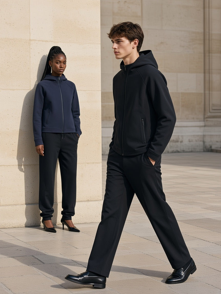 Two people in the Marcel Afters Paneled Full Zip Hoodie in Black and Navy Blue in a pale limestone Paris courtyard