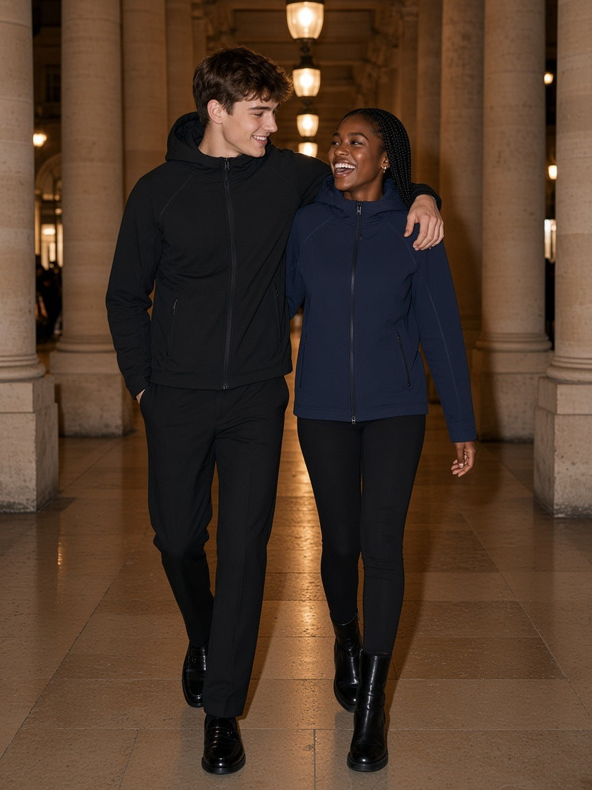 Two people in the Marcel Afters Paneled Full Zip Hoodie in Black and Navy Blue under the Palais Royal colonnade in Paris at night