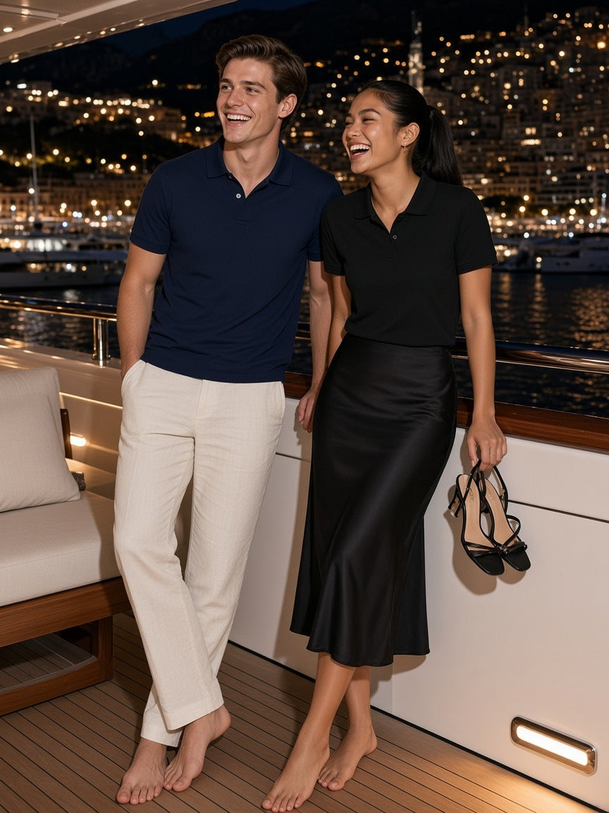 Two people in the Marcel Afters Regular Fit Polo Shirt in Navy Blue and Black on a yacht deck in Monaco at night