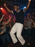 Man in the Ringer T-Shirt in Black, landing off the stage at a London basement gig at 2am